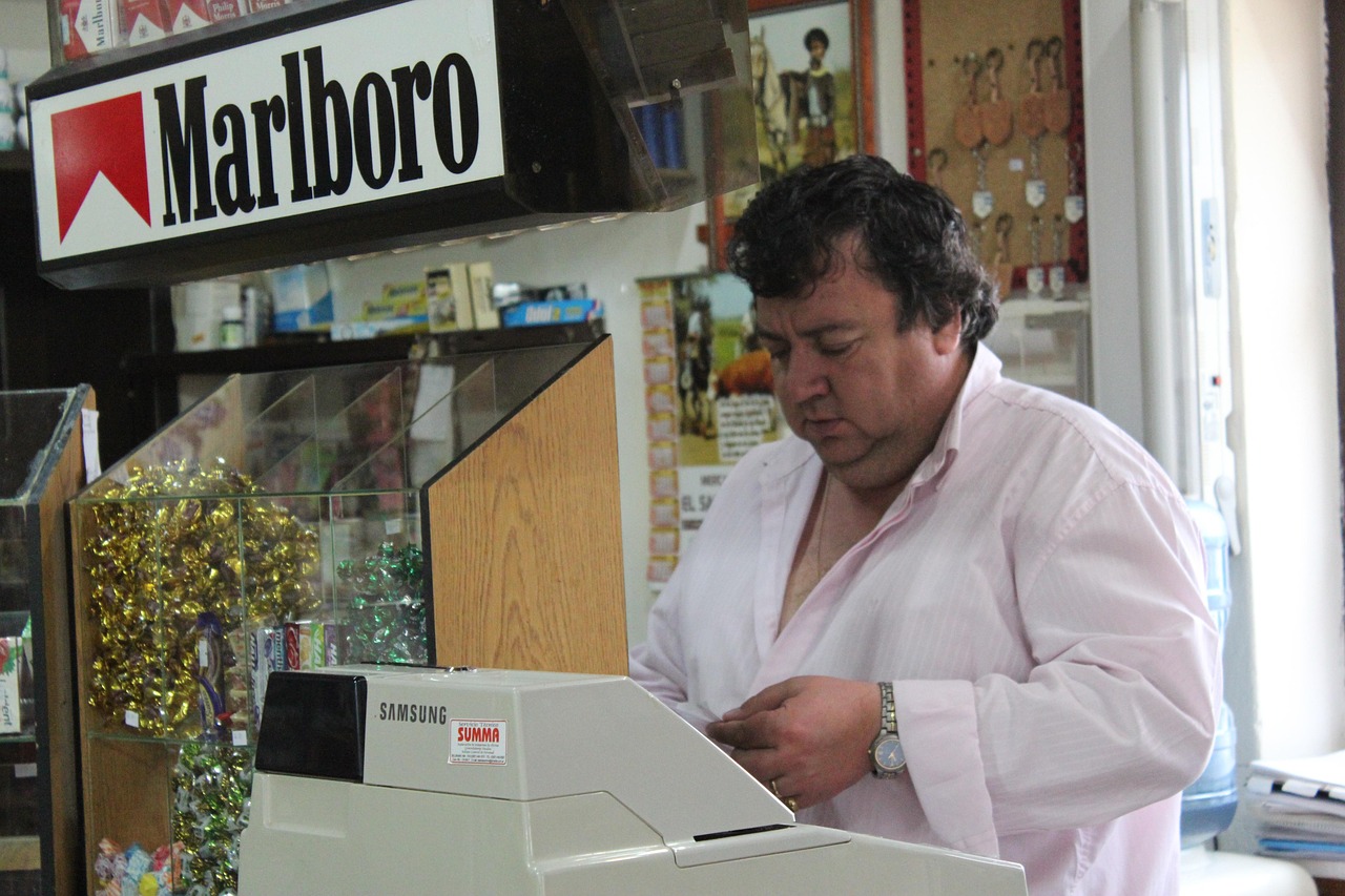 Giocatore felice mentre tiene un biglietto Gratta e Vinci vincente in una tabaccheria.